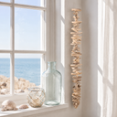 Treibholzkette — Kette am Fensterrahmen zwischen Glasflaschen und Muscheln